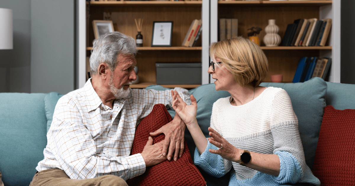 Couple on sofa discussing retirement