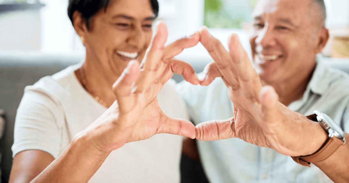 Couple making a heart with hands